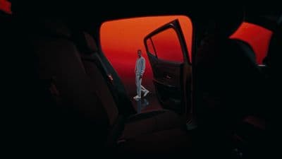 a man standing in the back seat of a car