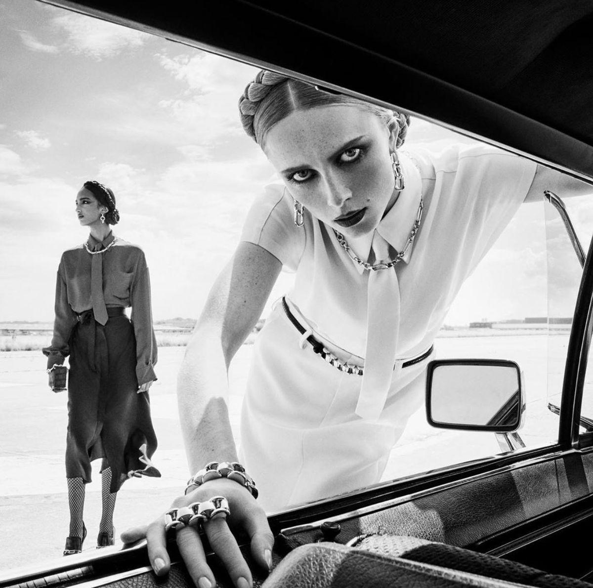 a black and white photo of two women in a car