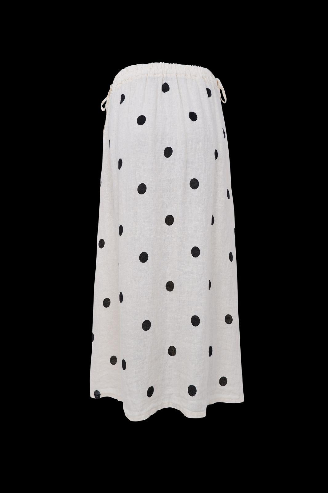 a white skirt with black dots on it