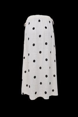 a white skirt with black dots on it