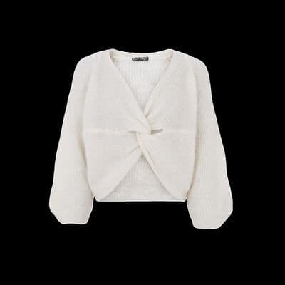a white sweater with a bow on the front