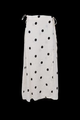 a white skirt with black dots on it
