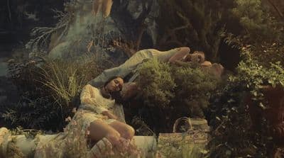 a painting of a man and a woman laying on the ground