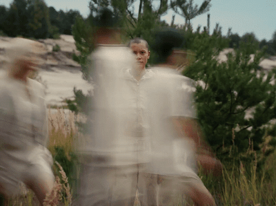a blurry photo of two men standing in a field
