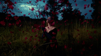 a woman standing in a field of flowers