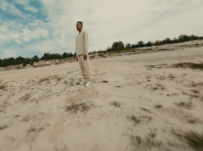 a man standing on top of a sandy beach