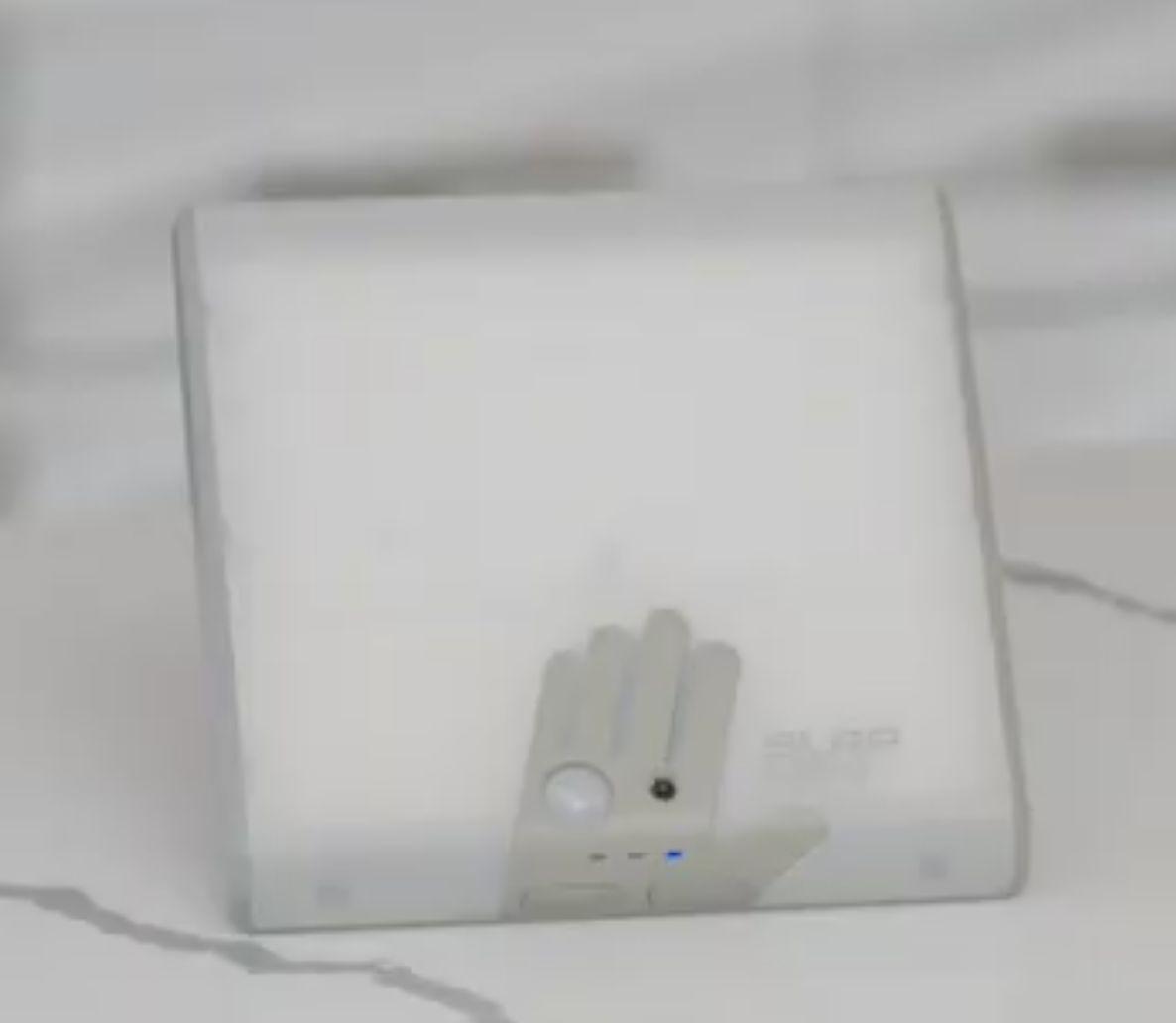 a white square object with a hand on it