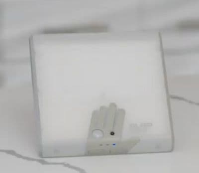 a white square object with a hand on it
