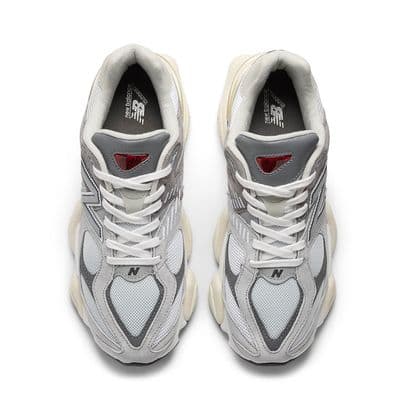 a pair of white and grey sneakers on a white background