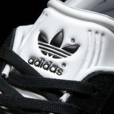 a close up of a white and black adidas shoe
