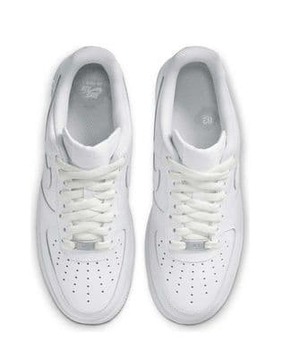 a pair of white sneakers on a white background