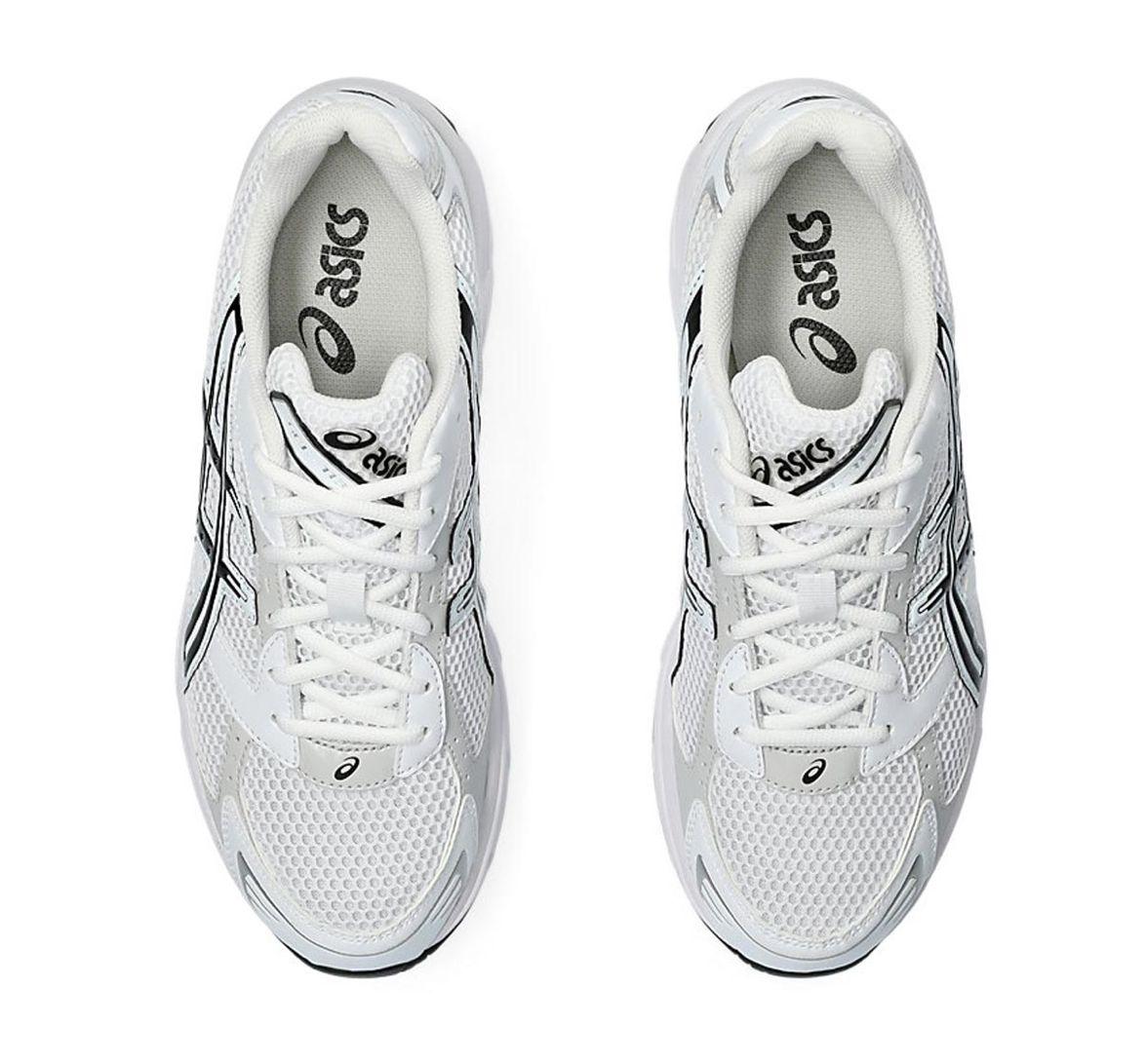 a pair of white sneakers with black accents