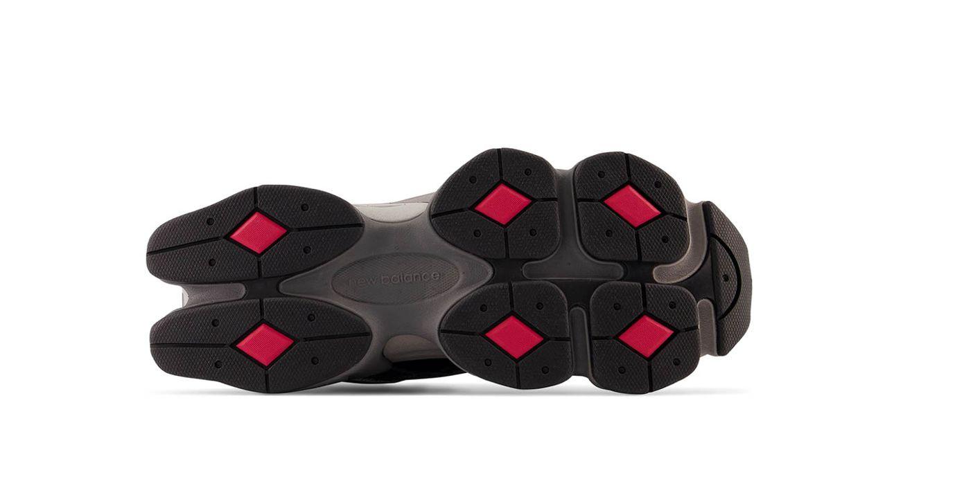 a pair of black and red shoes on a white background