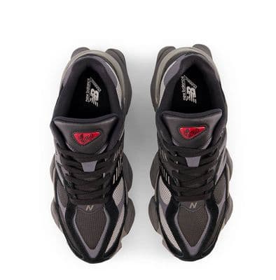 a pair of black and grey sneakers on a white background