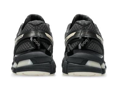 a pair of black and white sneakers on a white background