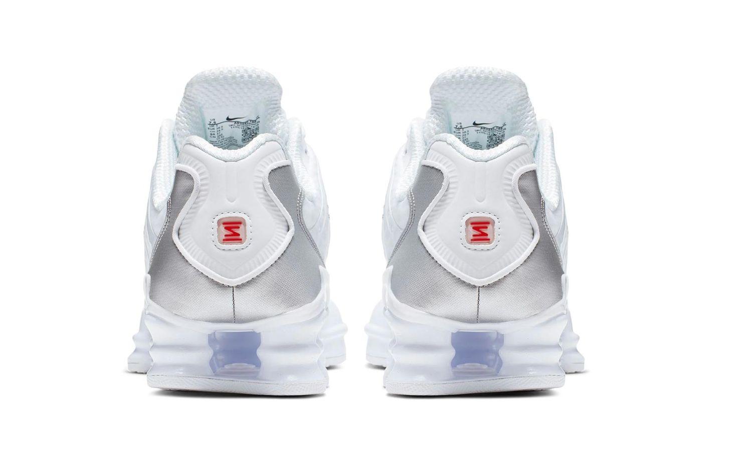 a pair of white and blue sneakers on a white background