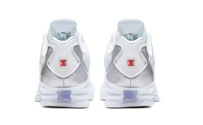 a pair of white and blue sneakers on a white background