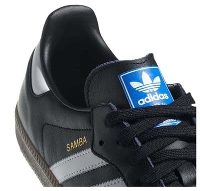 a black and white adidas sneakers with a blue logo