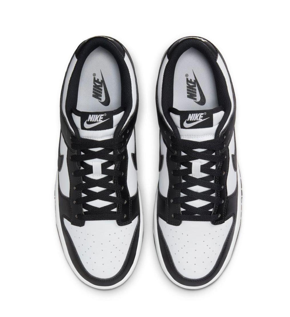 a pair of black and white sneakers on a white background