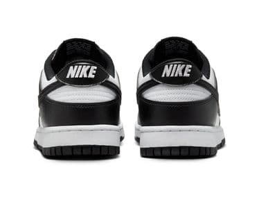 a pair of black and white shoes on a white background