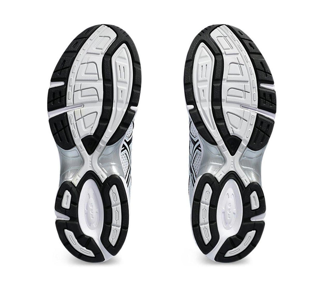 a pair of white and black shoes on a white background