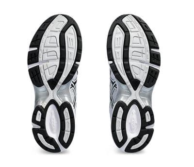 a pair of white and black shoes on a white background