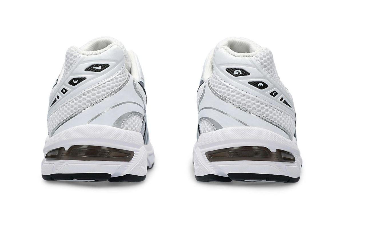 a pair of white sneakers on a white background