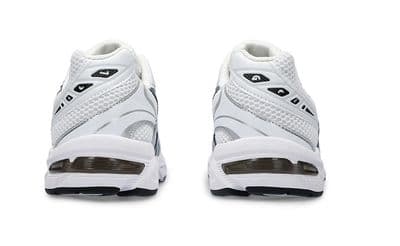 a pair of white sneakers on a white background
