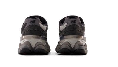 a pair of black and grey sneakers on a white background