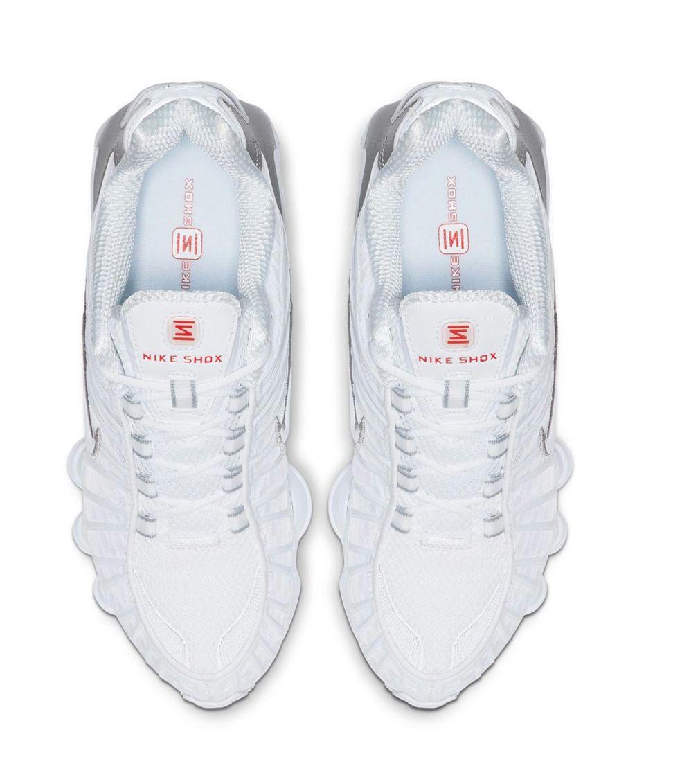 a pair of white sneakers on a white background