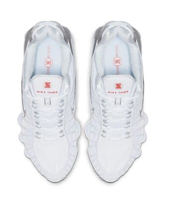a pair of white sneakers on a white background