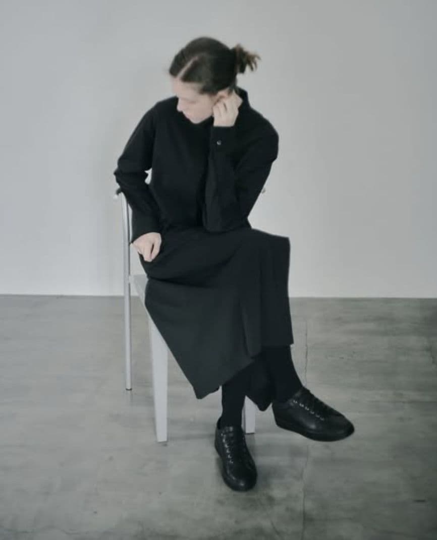 a woman sitting on a chair talking on a cell phone
