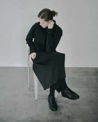 a woman sitting on a chair talking on a cell phone
