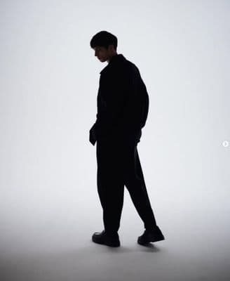 a man standing in the middle of a white room