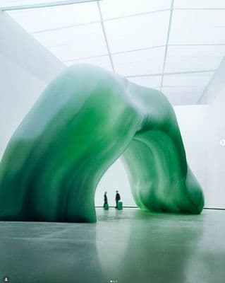 a large green piece of art in a room