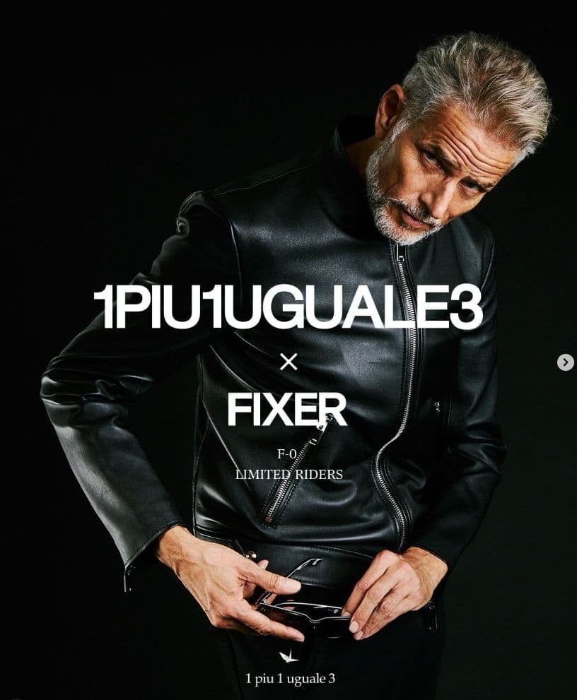 a man in a leather jacket holding his hands in his pockets