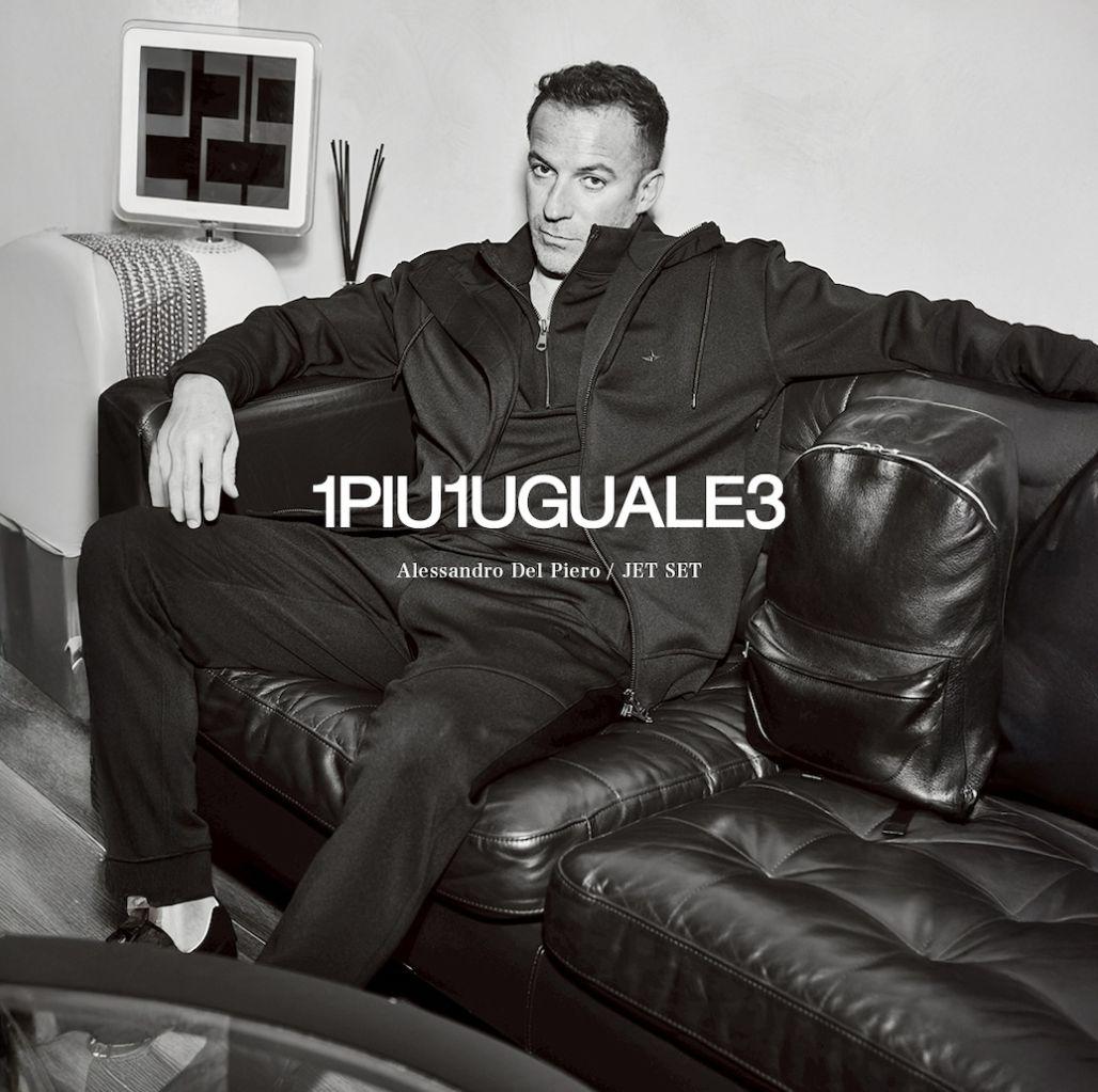 a black and white photo of a man sitting on a couch