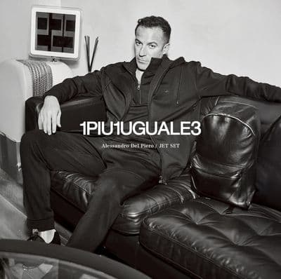 a black and white photo of a man sitting on a couch