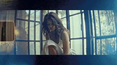 a woman standing in front of a window