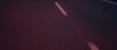 a blurry photo of a street with a stop sign