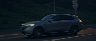 a car driving down a street at night