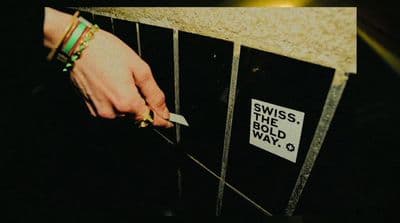 a person is cutting into a wall with a knife
