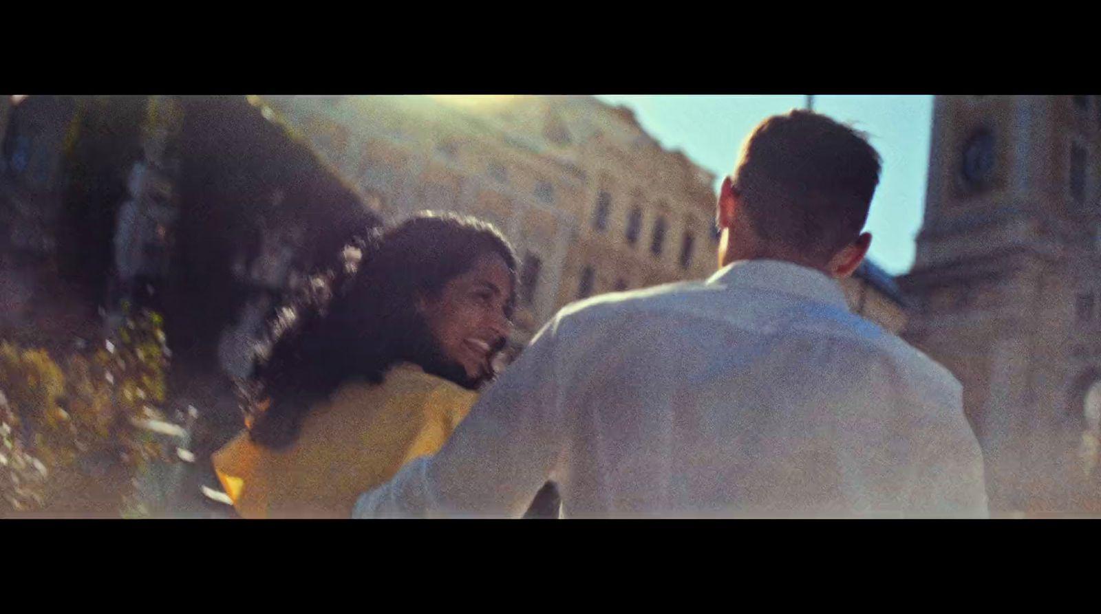 a man and a woman walking in front of a building