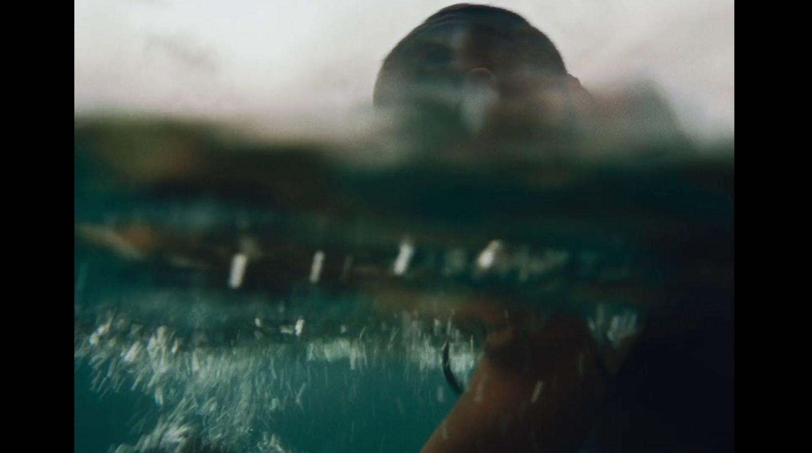 a blurry photo of a person swimming in the water