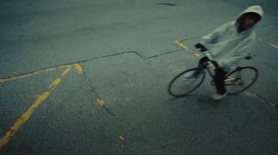 a person riding a bike down a street