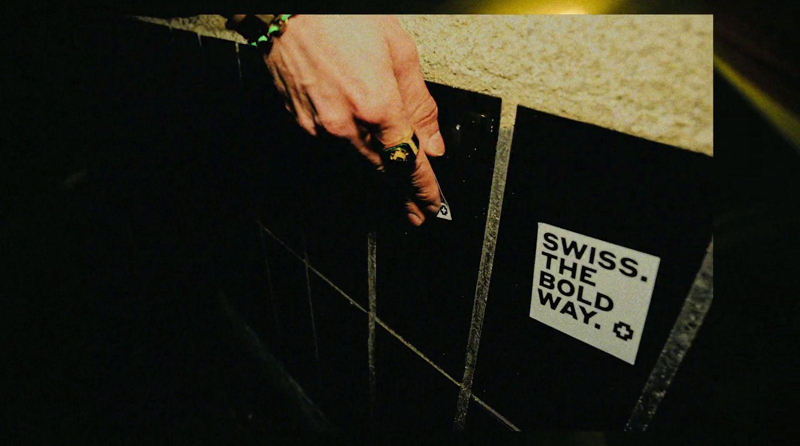 a person's hand on a wall with a sign on it