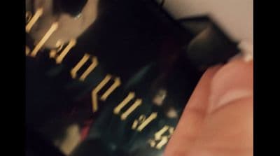 a close up of a person's hand holding a credit card