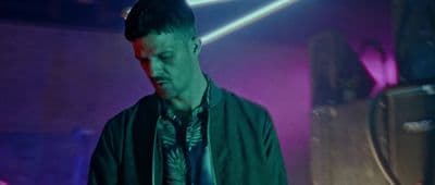 a man standing in front of a purple light