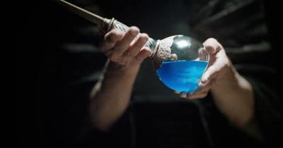 a person holding a blue substance in their hands