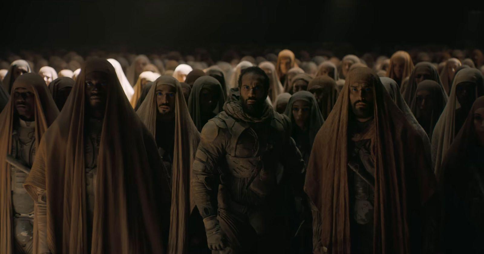 a large group of people standing in a dark room